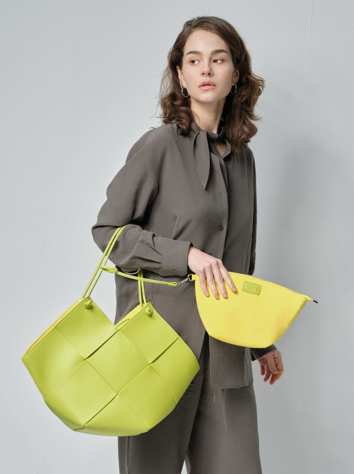 The Taylor in Kiwi Green, shown with the removable suede pouch that provides the bag's only internal organization