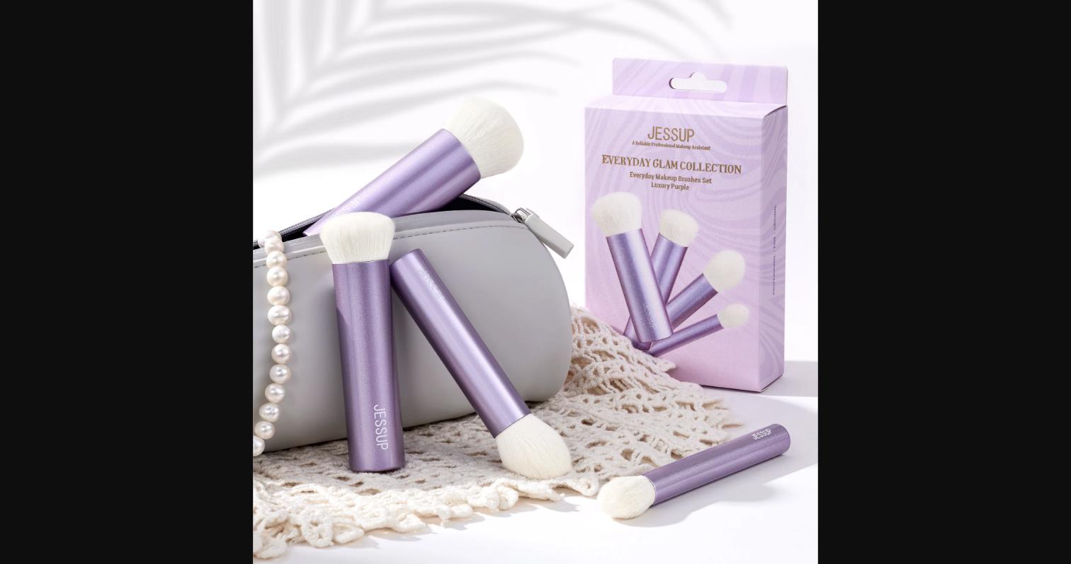 The Jessup Luxury Purple brush set styled with a makeup bag and pearls – showing the Everyday Glam Collection's premium look and feel.