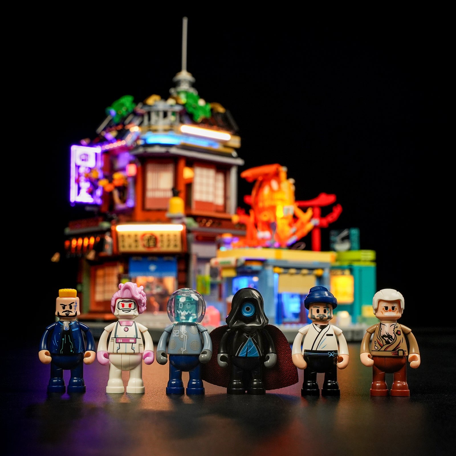 A closer look at the 6 included minifigures against the lit-up build — worth judging on its own before you decide if the character roster fits your shelf