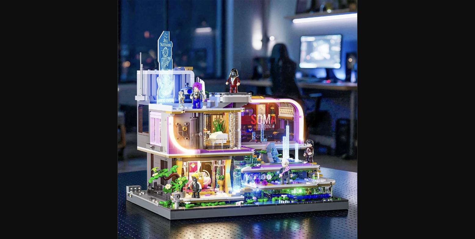 LumiBricks Neon Elite Lounge displayed on a desk — all 18 LEDs active, showing the ice-blue rooftop neon sign, illuminated bar and lounge interior, garden fountain lights, and five minifigures placed across the build.