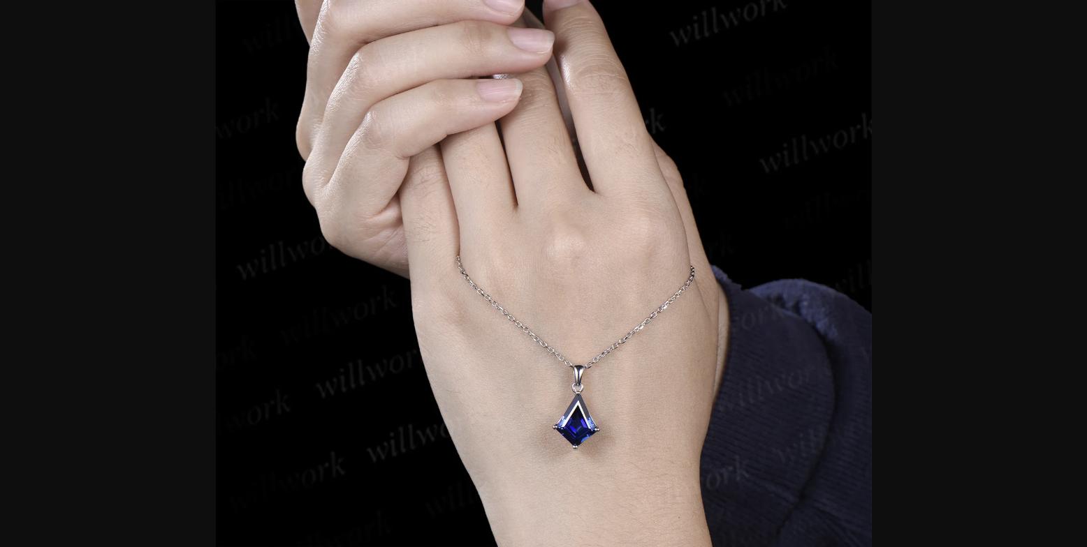 WillWork Jewelry kite cut blue sapphire necklace worn — the 10x13mm stone has strong presence on the chain with the deep blue lab sapphire catching light from multiple angles.